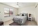 Cozy bedroom featuring a large window, ceiling fan, and comfortable, stylish bed at 2245 Leisure World --, Mesa, AZ 85206