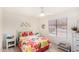 Bright bedroom featuring a ceiling fan, and a bed with colorful floral-themed bedding at 2245 Leisure World --, Mesa, AZ 85206