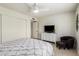 Cozy bedroom with a ceiling fan, closet, access to bathroom, and comfortable chair and ottoman at 2245 Leisure World --, Mesa, AZ 85206