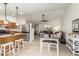 Open kitchen and dining area features modern appliances, bar seating, and an open layout to living area at 2245 Leisure World --, Mesa, AZ 85206