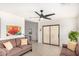 Relaxing living room with neutral colored sofas, ceiling fan, and sliding glass door for seamless indoor-outdoor living at 2245 Leisure World --, Mesa, AZ 85206