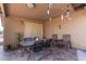 Covered patio with tile flooring, outdoor dining set, and decorative hangings at , Mesa, AZ 85206