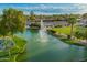 Enjoy serene walking paths and community amenities with this aerial view of a scenic pond at 2245 Leisure World --, Mesa, AZ 85206