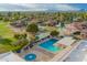Aerial view of the community pool and spa with patio seating with a lake and mountain view at 2245 Leisure World --, Mesa, AZ 85206