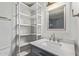 Bathroom featuring modern fixtures, a tiled shower, vanity, and open shelving at 1006 E Osborn Rd # B, Phoenix, AZ 85014