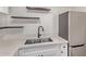 Close up of an updated kitchen featuring stainless steel appliances, stone counters, and dark floating shelves at 1006 E Osborn Rd # B, Phoenix, AZ 85014
