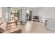 Bright living room featuring neutral walls, wood-look floors, and sliding glass doors to a treed outdoor area at 1006 E Osborn Rd # B, Phoenix, AZ 85014