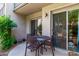 Outdoor patio with a table and chairs, accessible through sliding glass doors, and landscaped with foliage at 1006 E Osborn Rd # B, Phoenix, AZ 85014