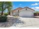 Charming single-story home with a well-manicured front yard and a two-car garage at 1120 S Valley Dr, Apache Junction, AZ 85120