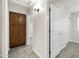 Bright hallway features a tiled floor, built-in cabinet, and leads to other rooms in the home at 1120 S Valley Dr, Apache Junction, AZ 85120