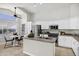 Open-concept kitchen featuring white cabinets, stainless steel appliances, and island with breakfast bar at 1120 S Valley Dr, Apache Junction, AZ 85120