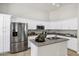 Bright kitchen featuring white cabinets, stainless steel appliances, and functional center island at 1120 S Valley Dr, Apache Junction, AZ 85120