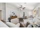 Open-concept living room with neutral decor, a ceiling fan, and tile flooring at 1120 S Valley Dr, Apache Junction, AZ 85120