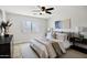 Cozy bedroom showcasing a bed with decorative pillows, ceiling fan, and a window at 1120 S Valley Dr, Apache Junction, AZ 85120