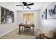 Functional home office with dark ceiling fan, neutral paint, and natural light, ready for productivity at 1120 S Valley Dr, Apache Junction, AZ 85120