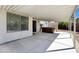 Covered patio includes a hot tub, access door, and privacy fence at 1120 S Valley Dr, Apache Junction, AZ 85120