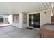 Covered patio offers a sliding glass door and access to a hot tub at 1120 S Valley Dr, Apache Junction, AZ 85120