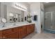 Stylish bathroom with double sink vanity, decorative vases, and glass-enclosed shower for a spa-like experience at 16801 N 94Th St # 2056, Scottsdale, AZ 85260
