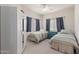 Neutral-toned bedroom features two twin beds and a ceiling fan at 16801 N 94Th St # 2056, Scottsdale, AZ 85260