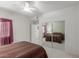 Large bedroom with ample closet space and a view to a second bedroom across the hallway at 16801 N 94Th St # 2056, Scottsdale, AZ 85260