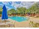Community pool with chairs, umbrellas, fountains, and desert landscaping at 16801 N 94Th St # 2056, Scottsdale, AZ 85260
