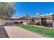 A spacious backyard offers a new patio cover with grassy area, a BBQ and a dining set, all surrounded by gravel at 1701 W Clarendon Ave, Phoenix, AZ 85015