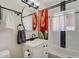 Well-lit bathroom with a new vanity, modern black fixtures and hardware, decorative tile and a brightly patterned shower curtain at 1701 W Clarendon Ave, Phoenix, AZ 85015