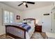 A charming bedroom features a ceiling fan, wood-look flooring, white walls, and updated window shutters at 1701 W Clarendon Ave, Phoenix, AZ 85015