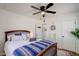 This nicely decorated bedroom features a ceiling fan, wood-look flooring, white walls and updated window shutters at 1701 W Clarendon Ave, Phoenix, AZ 85015