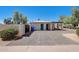 Charming exterior features a covered porch, white stucco, and a spacious driveway, perfect for parking at 1701 W Clarendon Ave, Phoenix, AZ 85015