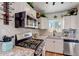 Updated kitchen features granite counters, stainless appliances, and mosaic tile backsplash at 1701 W Clarendon Ave, Phoenix, AZ 85015