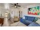 Cozy living room features a blue sofa, wood floors, and an open layout with a view into the dining area at 1701 W Clarendon Ave, Phoenix, AZ 85015