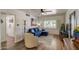 Bright living room with a blue couch, wood floors, shutters, and a ceiling fan, creating a comfortable and stylish space at 1701 W Clarendon Ave, Phoenix, AZ 85015