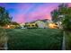 Expansive backyard with lush green grass, a pool, and the home's exterior at 17690 E Bronco Dr, Queen Creek, AZ 85142
