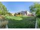 Expansive backyard featuring a well-maintained lawn, beautiful landscaping, and luxury outdoor living at 17690 E Bronco Dr, Queen Creek, AZ 85142