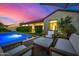 Backyard patio area featuring modern outdoor furniture and views of the sparkling pool at 17690 E Bronco Dr, Queen Creek, AZ 85142
