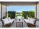 Framed view of backyard oasis, highlighting the pool and beautifully landscaped greenery at 17690 E Bronco Dr, Queen Creek, AZ 85142