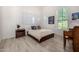 Bedroom featuring a comfortable bed, hardwood floors, and natural lighting at 17690 E Bronco Dr, Queen Creek, AZ 85142