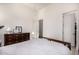 This bright bedroom with wood-look floors offers ample closet space and natural light from a transom window at 17690 E Bronco Dr, Queen Creek, AZ 85142
