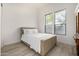 Bedroom featuring a comfortable bed, hardwood floors, and natural lighting at 17690 E Bronco Dr, Queen Creek, AZ 85142