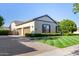 Beautiful home exterior with well-manicured lawn, a paved driveway, and a three-car garage at 17690 E Bronco Dr, Queen Creek, AZ 85142