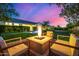 Inviting backyard fire pit and in ground pool for entertaining at night at 17690 E Bronco Dr, Queen Creek, AZ 85142