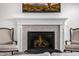 Contemporary fireplace featuring stacked tile surround, decorative mantel, and a wall-mounted television at 17690 E Bronco Dr, Queen Creek, AZ 85142