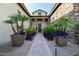 Inviting front entrance with stone pathway, manicured landscaping, and a charming covered porch at 17690 E Bronco Dr, Queen Creek, AZ 85142