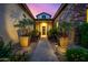 Inviting front entrance with stone pathway, manicured landscaping, and a charming covered porch at 17690 E Bronco Dr, Queen Creek, AZ 85142