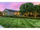 Lush front yard with mature trees and manicured lawn enhances the curb appeal of this home at 17690 E Bronco Dr, Queen Creek, AZ 85142