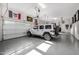 Spacious three car garage features a painted floor, plenty of wall storage and two Jeep Wranglers at 17690 E Bronco Dr, Queen Creek, AZ 85142