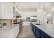 Contemporary kitchen featuring quartz counters, stainless appliances, blue island, pendant lights, and ample cabinet space at 17690 E Bronco Dr, Queen Creek, AZ 85142