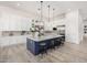 Modern kitchen featuring a navy island, stainless steel appliances, white cabinets, and stylish pendant lighting at 17690 E Bronco Dr, Queen Creek, AZ 85142