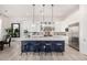 Elegant kitchen with blue island, quartz countertops, white cabinetry, stainless steel appliances, and modern pendant lights at 17690 E Bronco Dr, Queen Creek, AZ 85142